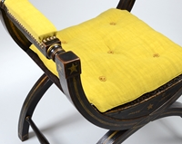 An Ebonised and Gilt Decorated Regency Period X-Framed Armchair