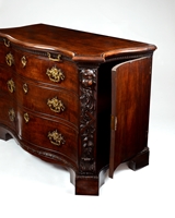 A PAIR OF GEORGE II PERIOD SERPENTINE FRONTED MAHOGANY COMMODES ATTRIBUTED TO THE WORKSHOP OF WILLIAM VILE OR WILLIAM HALLETT THE CARVING POSSIBLY BY JOHN BOSON