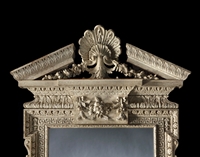 A GEORGE I PERIOD CARVED MIRROR retaining its original paint