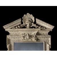 A GEORGE I PERIOD CARVED MIRROR retaining its original paint