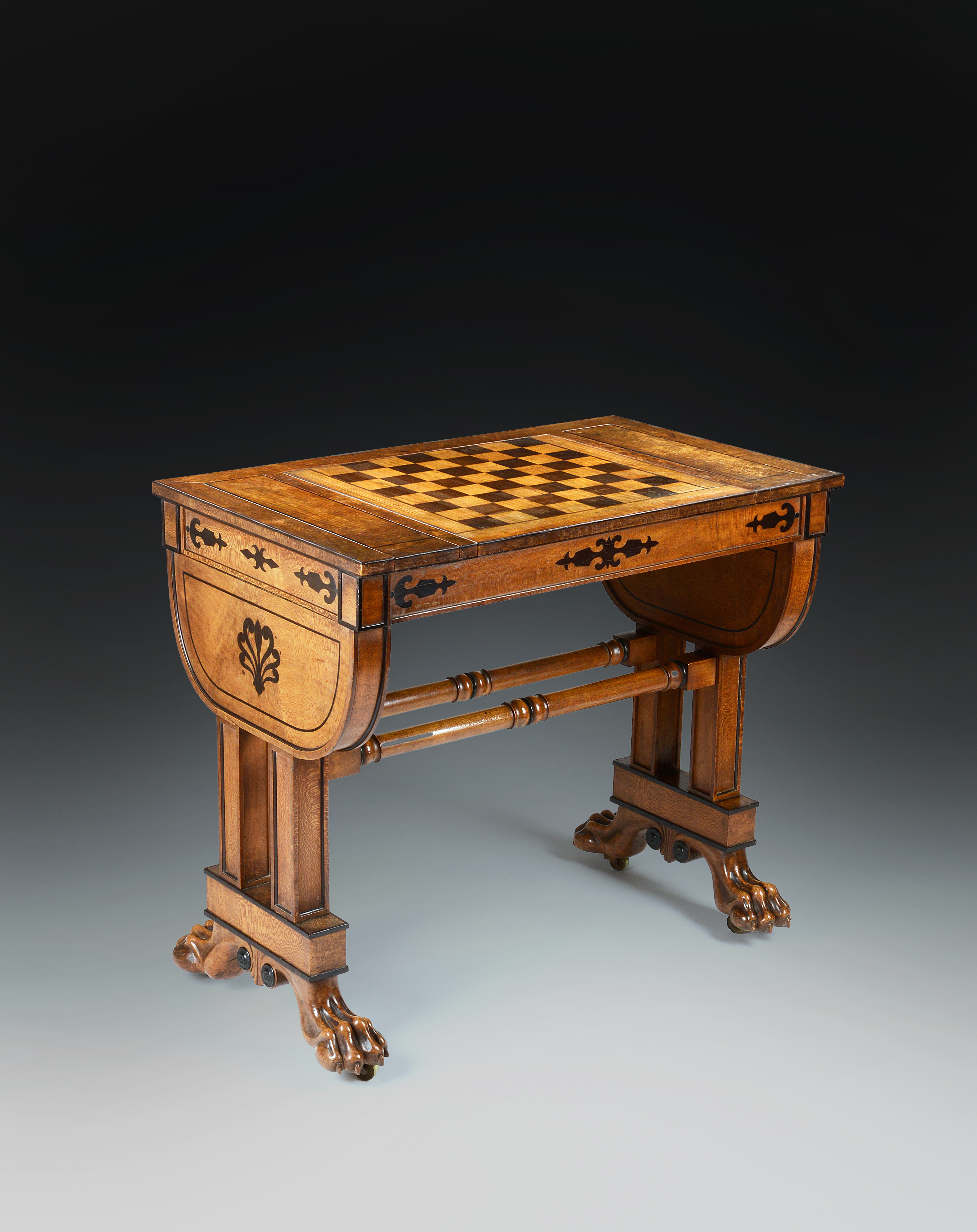 A Regency Period Games Table in Solid and Veneered Lacewood Inlaid with Ebony to a Design by George Smith