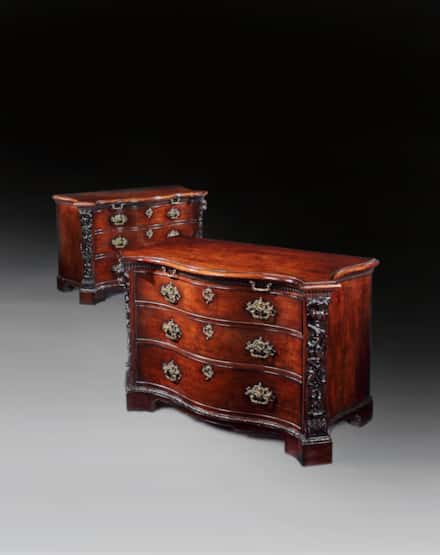 A PAIR OF GEORGE II PERIOD SERPENTINE FRONTED MAHOGANY COMMODES ATTRIBUTED TO THE WORKSHOP OF WILLIAM VILE OR WILLIAM HALLETT THE CARVING POSSIBLY BY JOHN BOSON